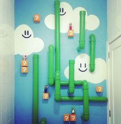 a bathroom decorated with green pipes and clouds