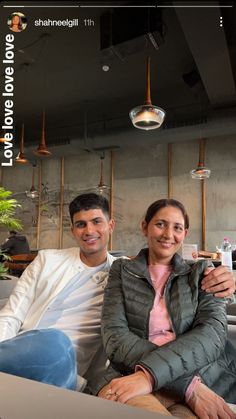 a man and woman sitting on a couch together