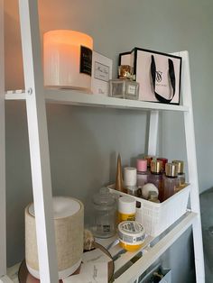 a white shelf filled with lots of beauty products