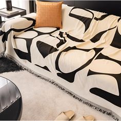 a black and white couch sitting on top of a rug