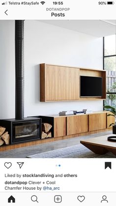 a living room with wood furniture and a flat screen tv mounted on the wall above it