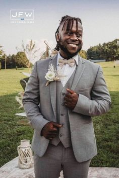 a man in a gray suit and bow tie