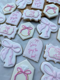 decorated cookies with pink and white icing on a table