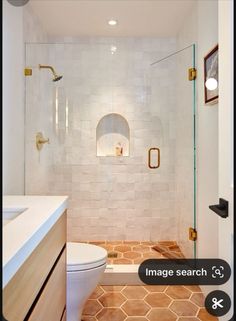 a bathroom with a toilet, sink and shower in it's own photo frame