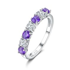 a white gold ring with purple stones