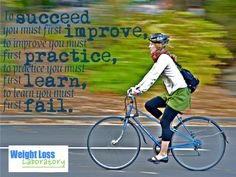 a woman riding a bike down a street with a quote on the front and back