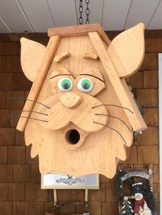 a wooden cat head hanging from the ceiling