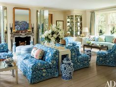 a living room filled with blue and white furniture