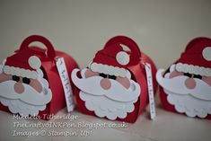 three red bags with santa claus on them