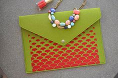 a green envelope with beads and a necklace on it