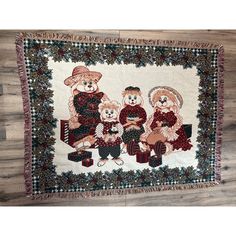 a wall hanging with three bears on it