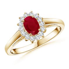 a yellow gold ring with an oval shaped ruby and white diamonds on the band, set in