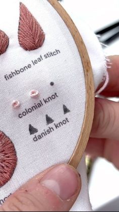 someone is stitching something with their hand on the embroidery hoop that they are holding