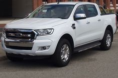 a white truck parked in front of a building