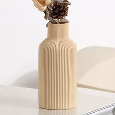 there is a vase with flowers in it on the table