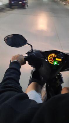 a person riding on the back of a motor scooter in a parking garage