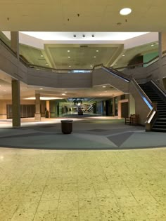 an empty lobby with stairs leading up to the second floor