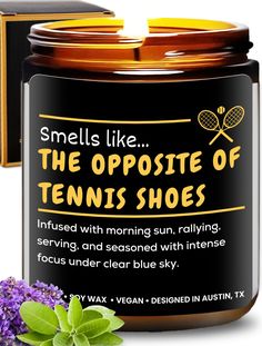 an open jar of tennis shoes next to purple flowers and a box with the words, smells like the opposite of tennis shoes