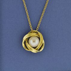 "This  Infinity pendant slide shaped like a love knot is a lovely way to tell her you are ready to \"tie the knot\". This pendant has soft naturally flowing lines forming a loose knot around the lustrous akoya quality freshwater pearl.  ---------- * made of Solid 14k gold.  * Pendant is 0.7 inch wide. * Pearl size: 9mm  * Pearl is the birthstone for June. * You can order with or without a 14k Rolo chain in the length of your choice at checkout * Comes beautifully gift wrapped, and ready for givi Elegant Twisted Jewelry For Gifts, Outlander Jewelry, Elegant Gold Necklace, Pearl Anniversary, Celtic Knot Jewelry, Celtic Love Knot, Gold Moon Necklace, Pearl Love, Gold Pendants