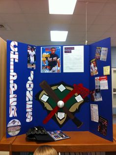 a baseball themed bulletin board in the middle of a room with posters and other items on it