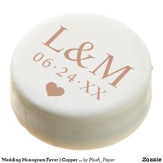 a round white box with the words love and m on it's side, in pink ink