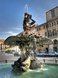 a fountain in the middle of a city square