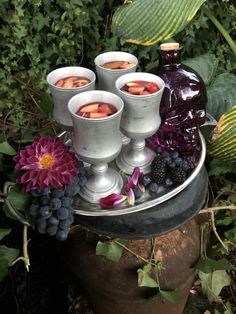 there are many glasses and some fruit on the table