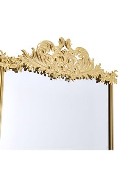 an ornate gold mirror is shown against a white background