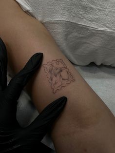 a woman's arm with a small tattoo on the left side of her leg