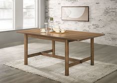 a wooden table sitting on top of a white rug