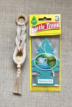 the little trees keychain has a tassel hanging from it's side