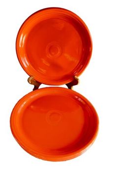 two orange plates sitting on top of each other