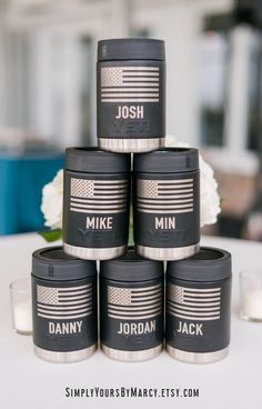 six personalized candles are stacked on top of each other with an american flag design