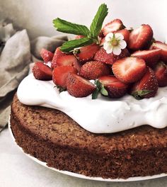 a cake with strawberries and whipped cream on top