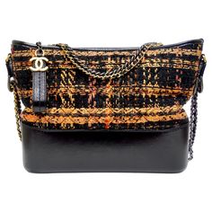 FOUND! The most perfect and versatile bag. From the 2018 Cruise collection this fabulous Gabrielle Hobo Bag is part of Chanel's new 'Gabrielle' line. This particular hobo bag features a sturdy base that provides structure for gorgeous orange and black tweed sides. The structure of the bag and the soft tweed gives you the best of both worlds. The bag comes with a unique chain strap featuring two mini chain and leather handles with and leather shoulder pad. The interior is perfect for holding your Prada Loafers, Expensive Bag, Cruise Collection, Black Peach, Black Tweed, Chanel Black, Daily Essentials, Leather Handles, Hobo Bag