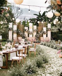 an outdoor dining area with tables and chairs set up for a formal function in the garden