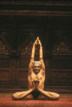 a naked man sitting on the floor doing yoga