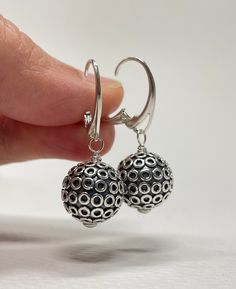 Sterling Silver Leverback Earrings. These sterling silver Bali ball bead earrings are handmade. 13mm large, oxidized beads with shiny circles are mounted on Euro-style leverback earring wires. The set is 1 3/8 inches (3.5 cm) in long. Pictures are enlarged to show detail. Gift for Wife, Girlfriend Gift, Gift for Mom, Gift for Sister, Gift for Her, Holiday Gift for Women. The earrings ship in a small organza bag inside a gift box, ready to give... or keep! To see more WireAndPearl Sterling Silver Hypoallergenic Round Earrings For Party, Pierced Sterling Silver Beaded Earrings As Gift, Gift Sterling Silver Pierced Beaded Earrings, Adjustable Silver Round Clip-on Earrings, Adjustable Round Silver Clip-on Earrings, Hypoallergenic Round Metal Earrings, Nickel-free Metal Beaded Earrings, Silver Round Beaded Earrings As Gift, Hypoallergenic Round Bead Party Earrings