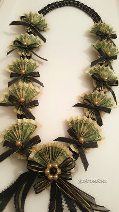 a necklace made out of dollar bills and ribbons