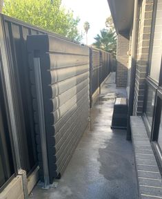 an outside view of a building with metal fence and gated in area next to it