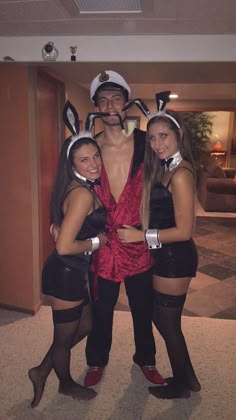 three people dressed up in costumes posing for the camera with one person wearing bunny ears