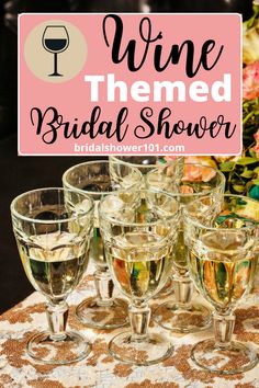 wine themed bridal shower with champagne glasses on the table and flowers in the background