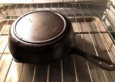 an old cast iron skillet sitting on top of the oven rack, ready to be cooked