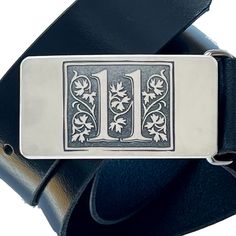 Elegant vines decorate this stainless steel number 11 belt buckle. Deep machine engraving is combined with hand fabrication for a buckle that is chic, elegant and built to last. Created entirely from stainless steel, its finish will remain silvery over its lifetime. Personalize it and add a date or initials or phrase on the back for a small fee. Add a beautiful handmade, snapped leather belt to make it a complete gift. Please include engraving requests and pants size in personalization box when Luxury Engraved Silver Belt Buckles, Rectangular Engraved Silver Belt Buckles, Silver Engraved Rectangular Belt Buckles, Rectangular Silver Engraved Belt Buckles, Silver Rectangular Engraved Belt Buckles, Classic Formal Belt Buckles With Engraved Logo, Classic Silver Buckle Belt Buckles As Gift, Classic Silver Buckle Belt As Gift, Classic Silver Belt Buckles As Gift