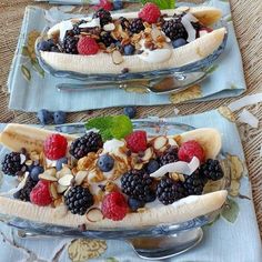 three plates with bananas, berries and nuts on them