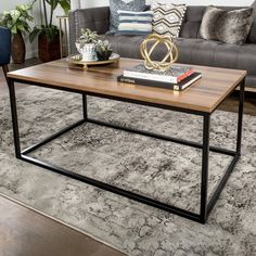 a coffee table sitting on top of a rug next to a couch