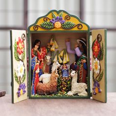 a nativity scene with figurines in an open box on a table top