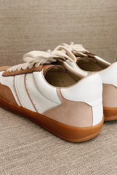 The Dixie Camel & White Lace Up Sneaker, a stylish and versatile addition to your footwear collection. These sneakers feature a sleek camel and white faux leather upper, offering a contemporary and chic look. The round toe design ensures comfort and ample space for your toes, while the lace-up details provide a secure and adjustable fit. The brown rubber sole offers excellent durability and traction, making these sneakers perfect for everyday wear. Whether you're running errands, heading to the Faux Leather Purse, Studded Necklace, Travel Dress, Faux Leather Belts, Jumpsuit Shorts Rompers, Footwear Collection, Bar Earrings, Toe Designs, Romper Pants