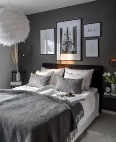 a bedroom with gray walls and pictures on the wall