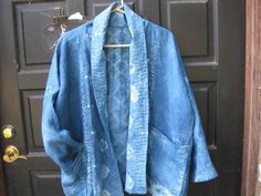 a blue jacket hanging on a black door